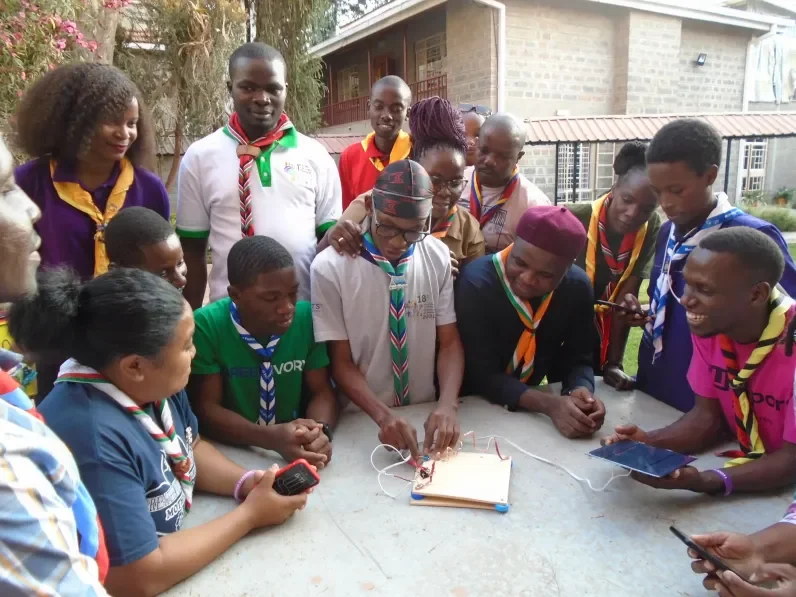 Scouts standing around a table